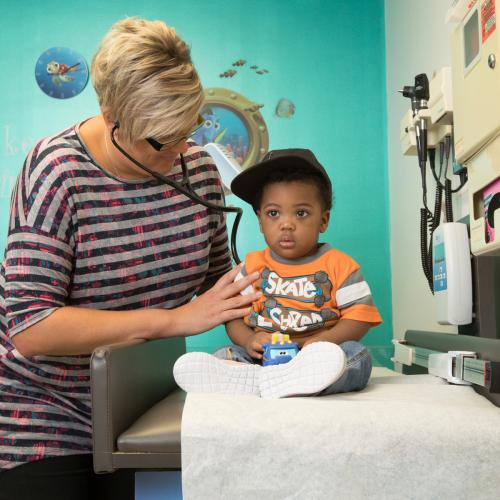 A doctor listens to a babies heart using a stethoscope