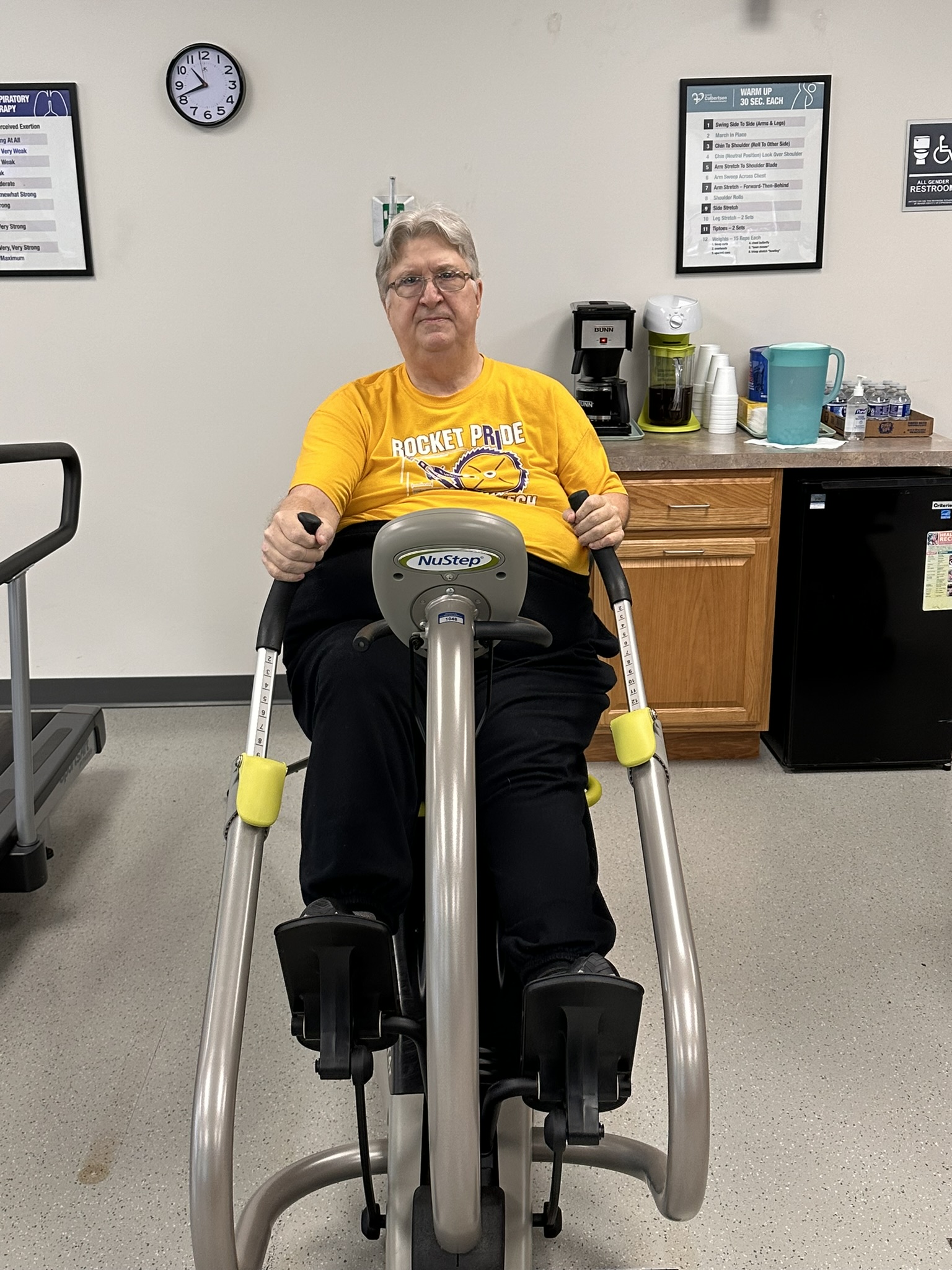 Man seated on a bike machine